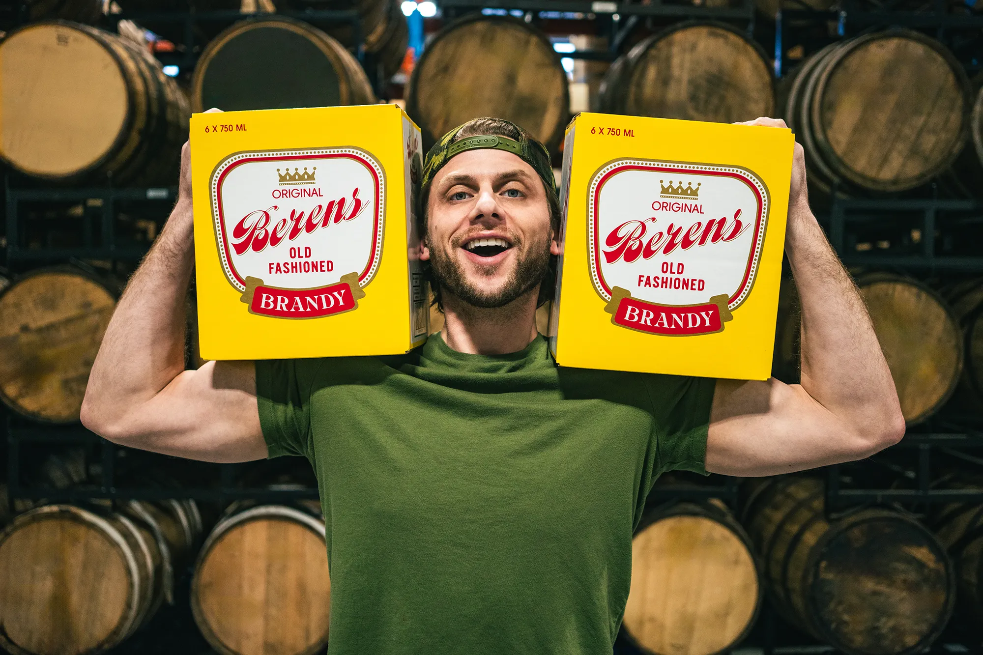 Charlie Berens holding cases of Berens Old Fashioned Brandy